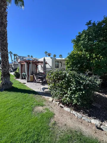 a view of a garden with a building in the background