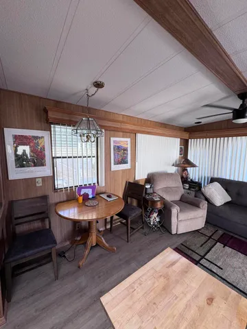 a living room with furniture a window and a table