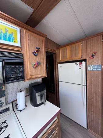 a kitchen with a refrigerator and a stove