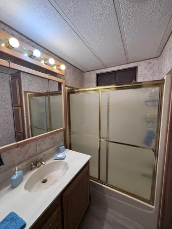 a bathroom with a sink and mirror