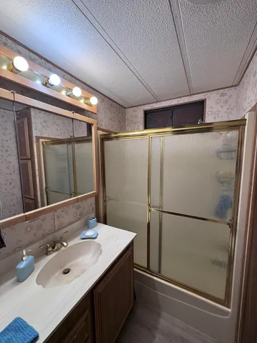 a bathroom with a sink and mirror