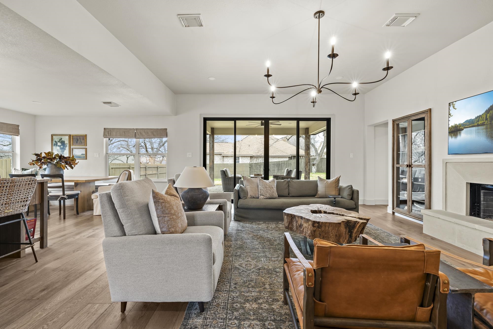 270 Chaparral Meadowlakes, TX 78654 - Photo 6 of 28 a living room with furniture a fireplace and a chandelier