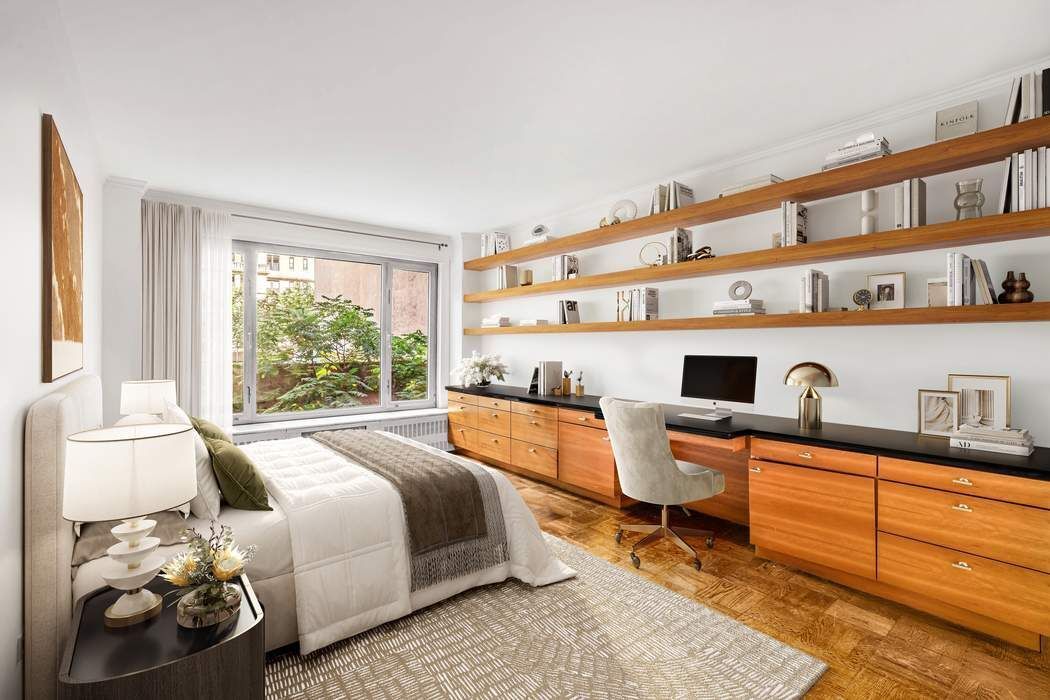 1050 5th Avenue, Unit 3B Manhattan, NY 10028 - Photo 11 of 13 a bedroom with a bed and a large window