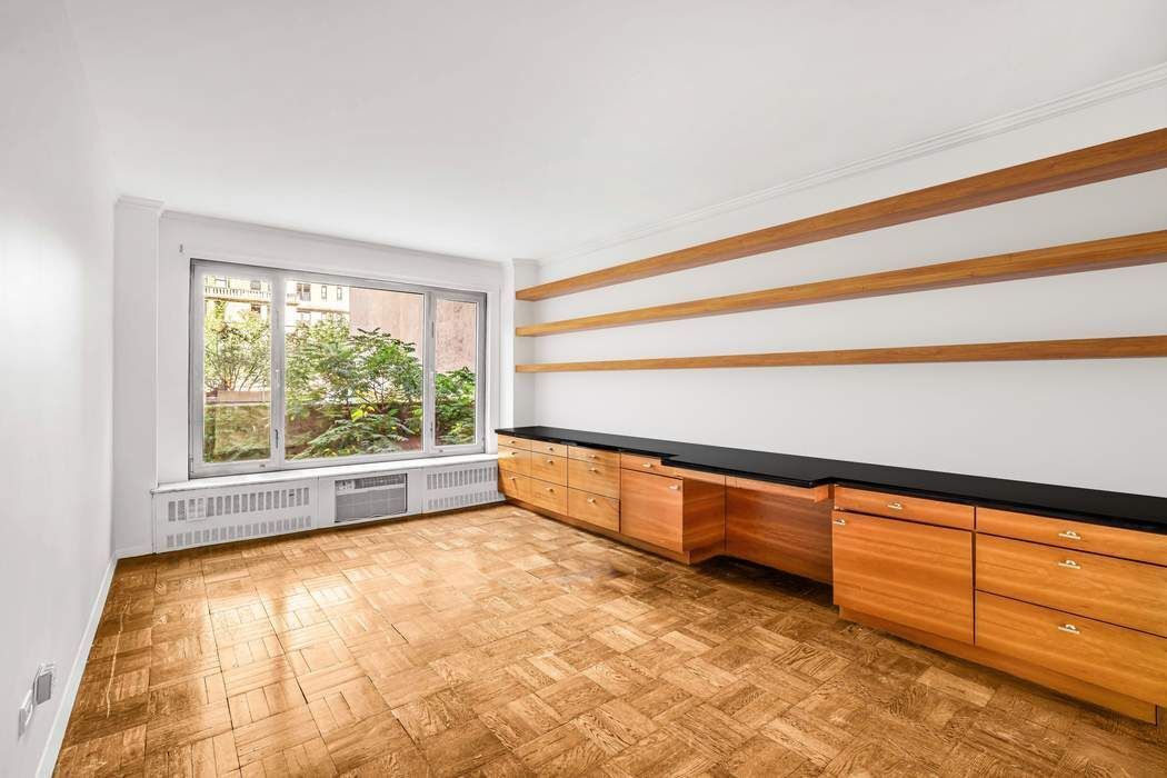 1050 5th Avenue, Unit 3B Manhattan, NY 10028 - Photo 12 of 13 a view of an empty room with a window