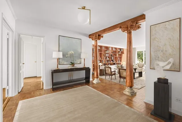 a view of an empty room with a fireplace and a window