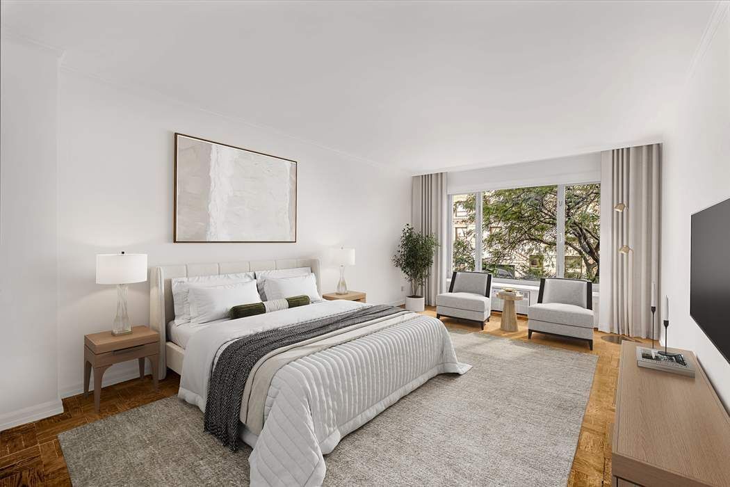 1050 5th Avenue, Unit 3B Manhattan, NY 10028 - Photo 9 of 13 a bedroom with a bed and large windows