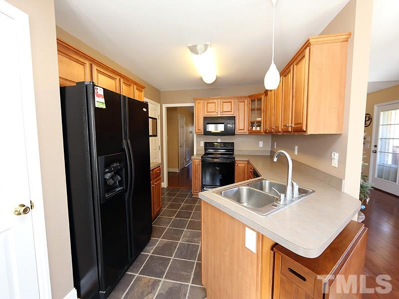 381 Hill Road Rougemont, NC 27572 - Photo 4 of 12 a kitchen with stainless steel appliances a sink stove and refrigerator