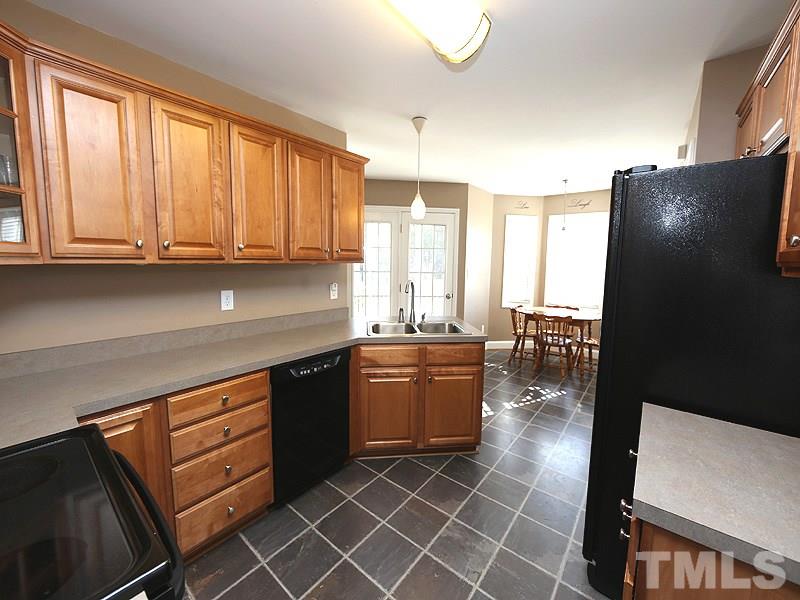 381 Hill Road Rougemont, NC 27572 - Photo 7 of 12 a kitchen with stainless steel appliances granite countertop a refrigerator a sink a stove and island
