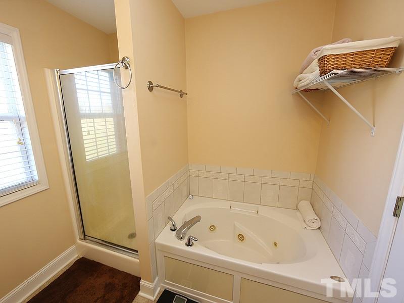 381 Hill Road Rougemont, NC 27572 - Photo 9 of 12 a bathroom with a bathtub and a window