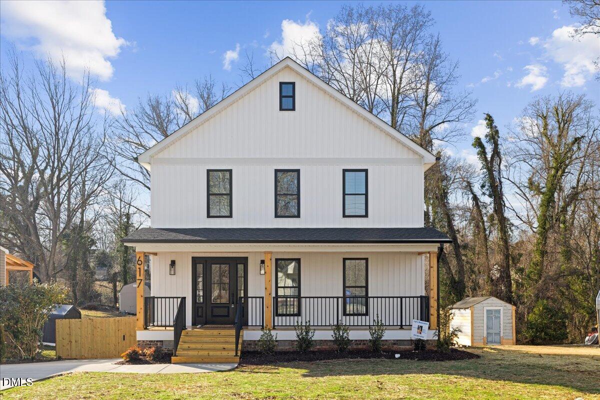 617 North 3rd Street Mebane, NC 27302 - Photo 3 of 50 a view of a white house with large windows and a tree