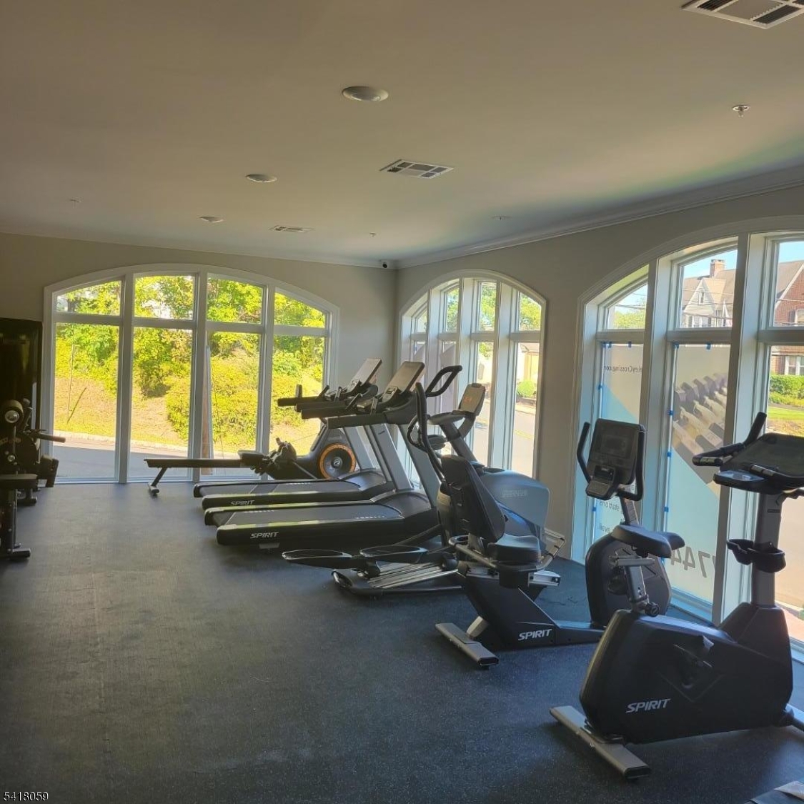 663 Springfield Avenue, Unit 53 Berkeley Heights, NJ 07922 - Photo 3 of 9 a room with gym equipment and a large window