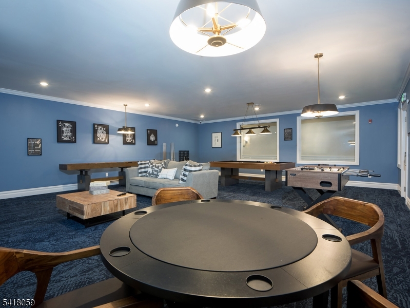 663 Springfield Avenue, Unit 53 Berkeley Heights, NJ 07922 - Photo 4 of 9 a living room with furniture a flat screen tv and kitchen view