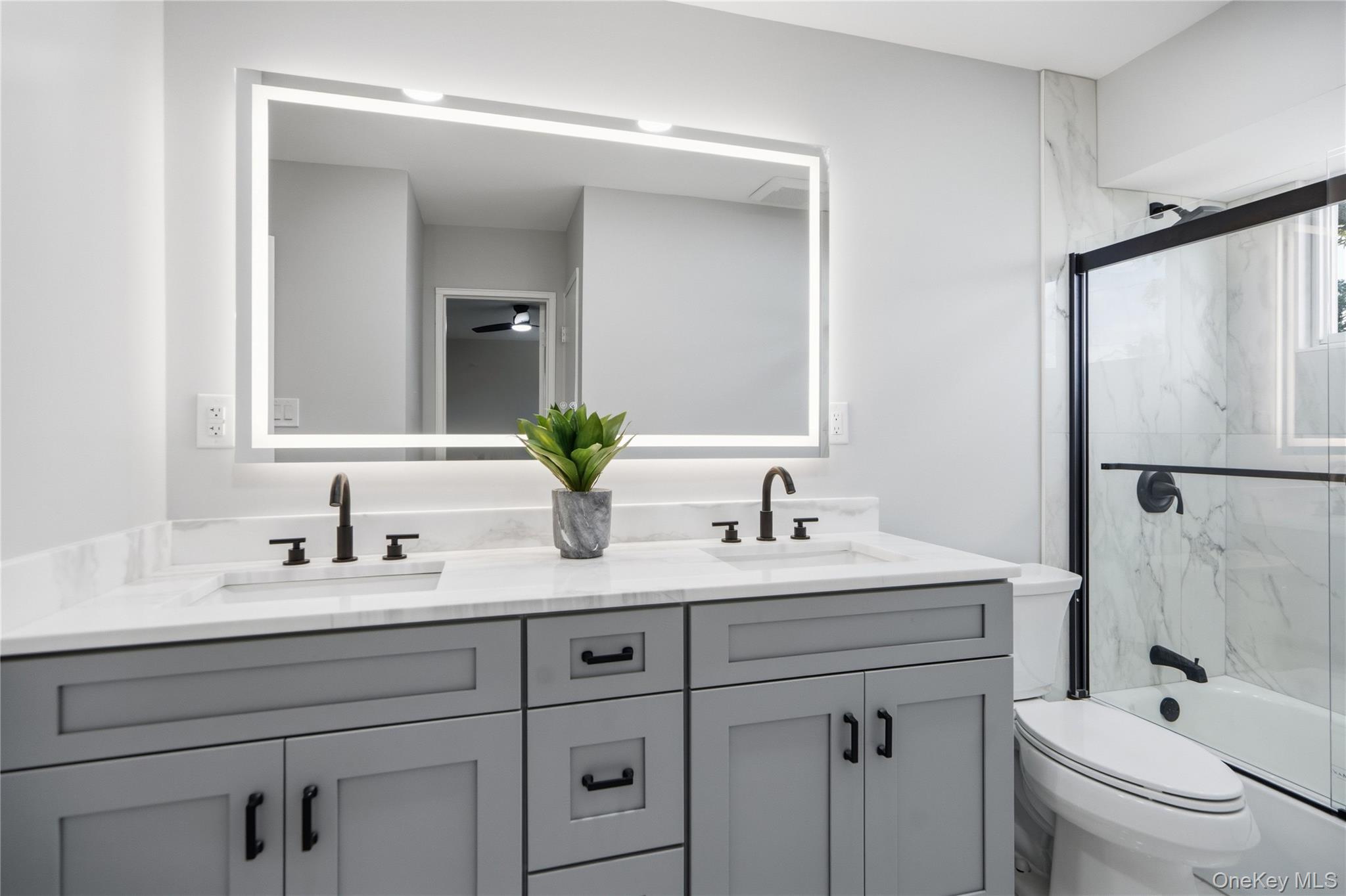 183 North Marginal Road Jericho, NY 11753 - Photo 18 of 28 Bathroom also features a clear glass enclosure and tub with white marble-look tile surround