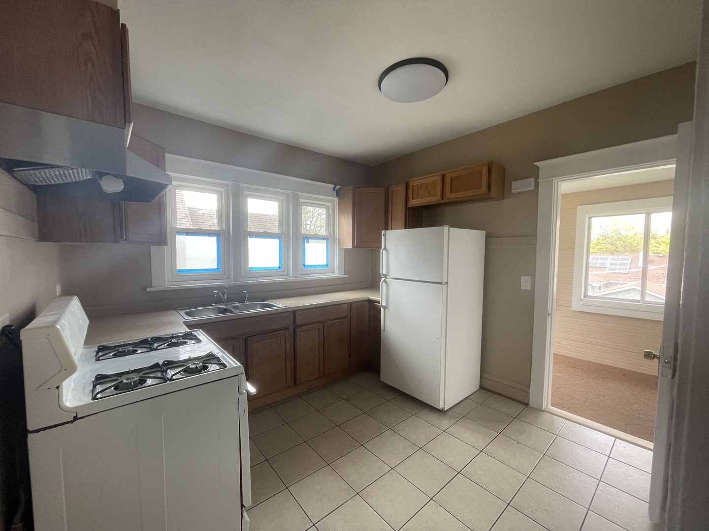 710 North Poplar Street, Unit 2 Waukegan, IL 60085 - Photo 14 of 16 a kitchen with a stove a refrigerator and a sink