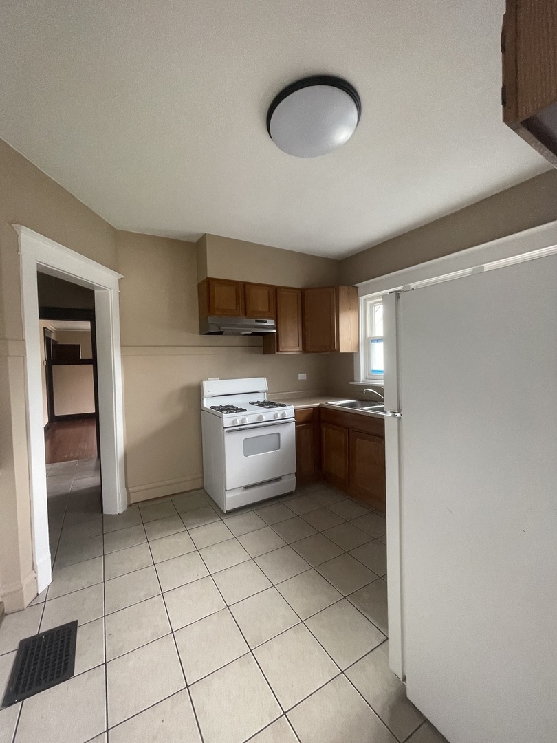 710 North Poplar Street, Unit 2 Waukegan, IL 60085 - Photo 15 of 16 a kitchen with stainless steel appliances a sink cabinets and a counter top space