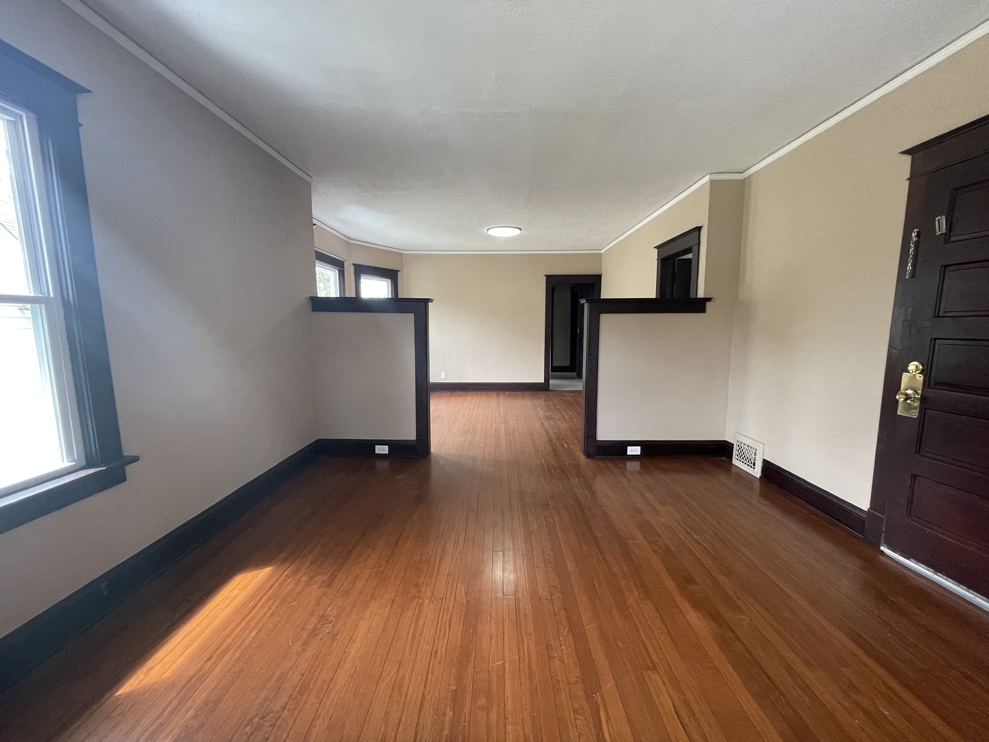 710 North Poplar Street, Unit 2 Waukegan, IL 60085 - Photo 5 of 16 a view of empty room with wooden floor and fan