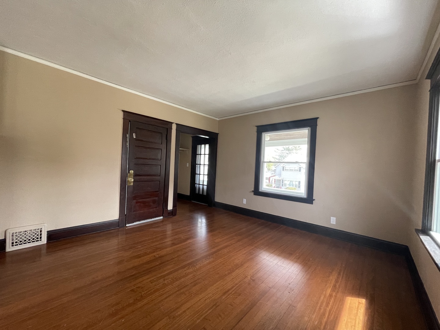 710 North Poplar Street, Unit 2 Waukegan, IL 60085 - Photo 6 of 16 a view of an empty room with wooden floor and a window