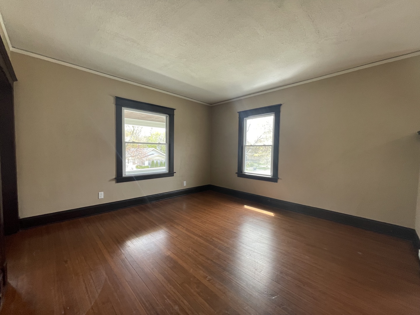 710 North Poplar Street, Unit 2 Waukegan, IL 60085 - Photo 7 of 16 an empty room with wooden floor and windows