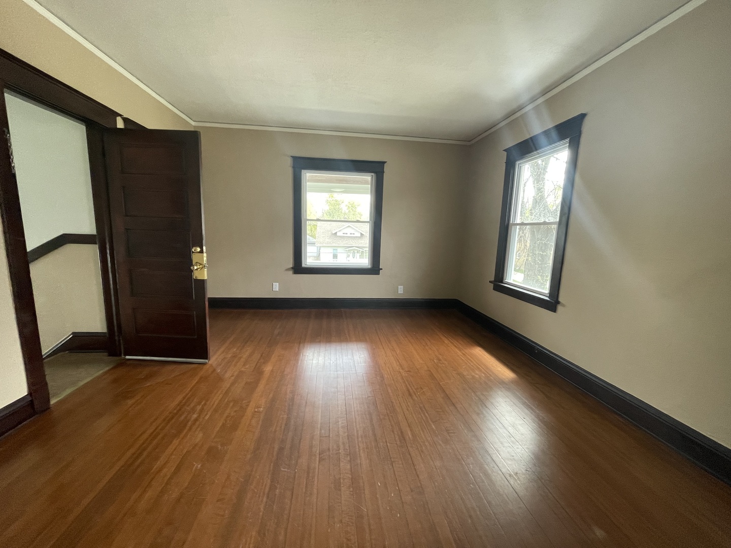 710 North Poplar Street, Unit 2 Waukegan, IL 60085 - Photo 8 of 16 an empty room with wooden floor and windows
