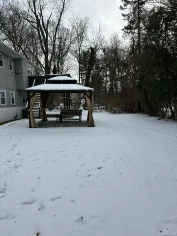 a view of parking with a car parked in front of yard