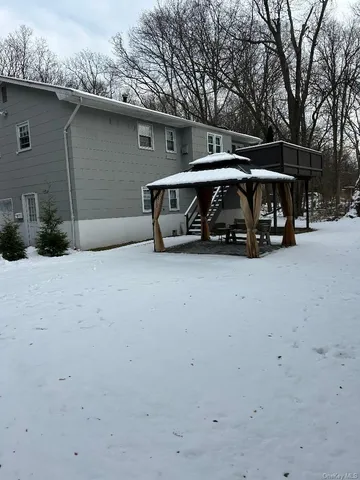 a view of backyard with a car and large trees