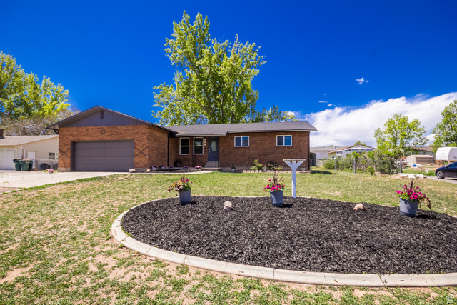 634 South 2100th Street West Vernal, UT 84078 - Photo 56 of 71 Brick ranch-style residence featuring an attached garage with an automatic door