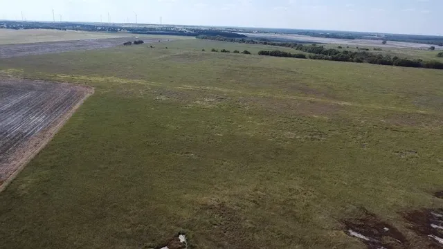 a view of an ocean next to a yard