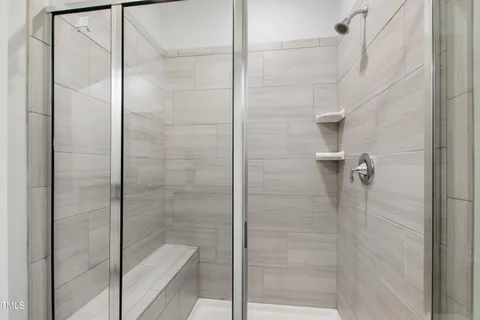 a bathroom with double sink and a mirror