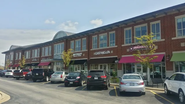 a store with outdoor seating area and blue umbrellas