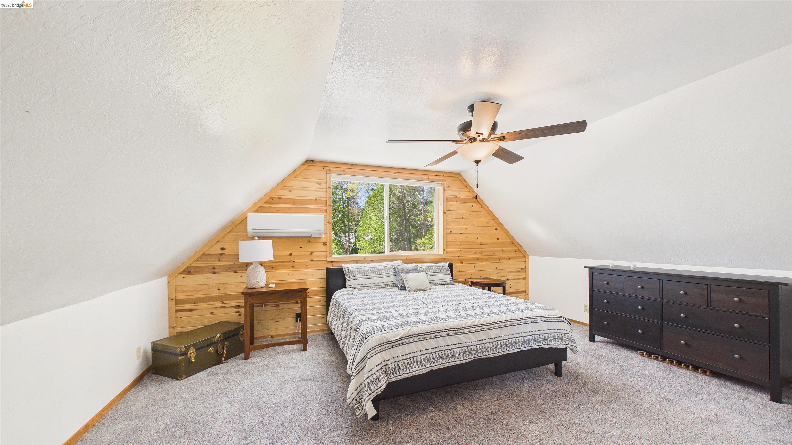 26570 Crystal Road Long Barn, CA 95335 - Photo 18 of 39 Vaulted ceiling bedroom with wood plank accent wall and window