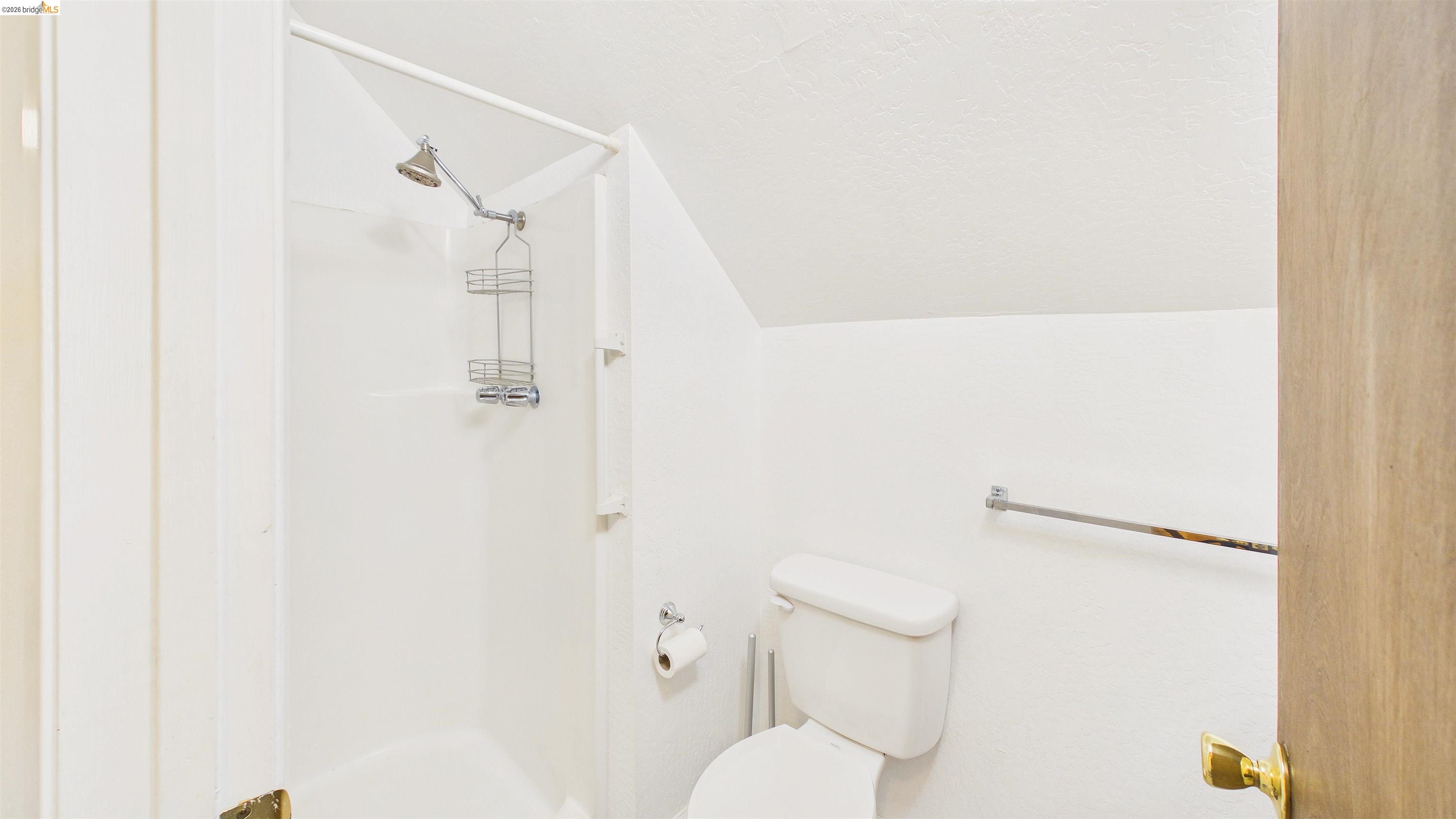 26570 Crystal Road Long Barn, CA 95335 - Photo 20 of 39 Bathroom featuring a white shower stall with a chrome shower head and a white toilet