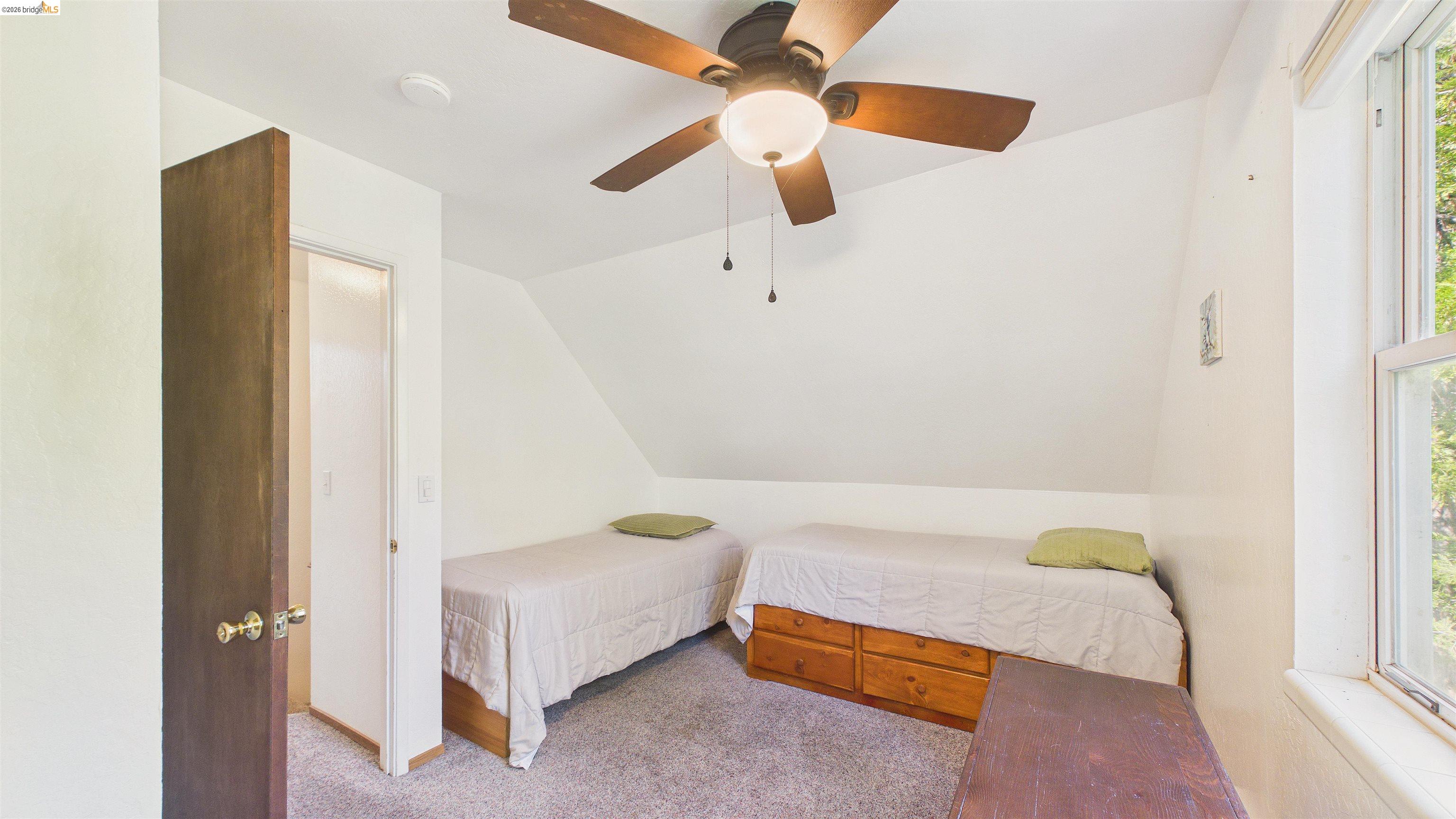 26570 Crystal Road Long Barn, CA 95335 - Photo 22 of 39 Carpeted room with a ceiling fan light fixture, sloped ceiling, and a single window