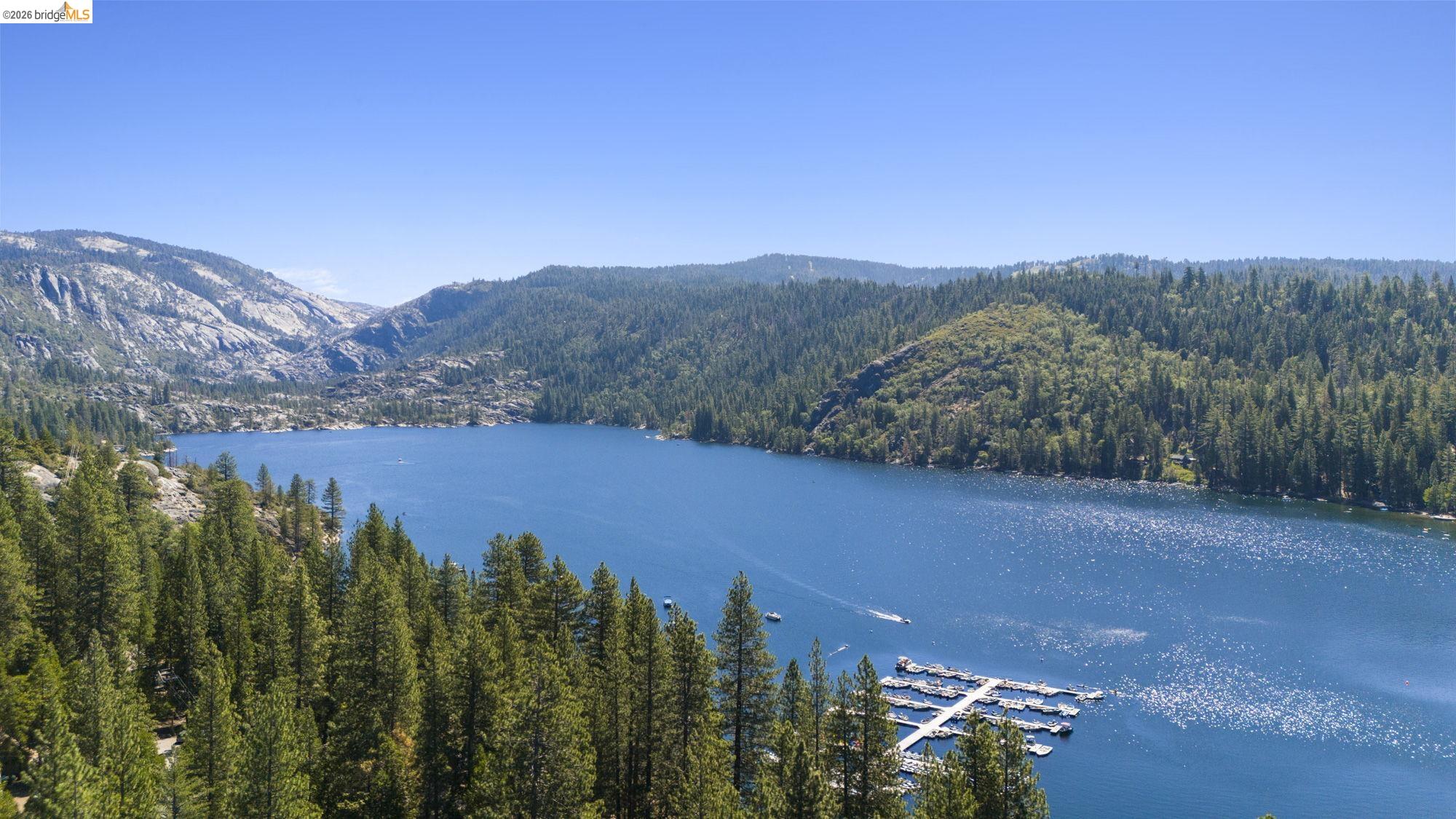 26570 Crystal Road Long Barn, CA 95335 - Photo 33 of 39 Expansive lake surrounded by dense evergreen forests and rugged mountains