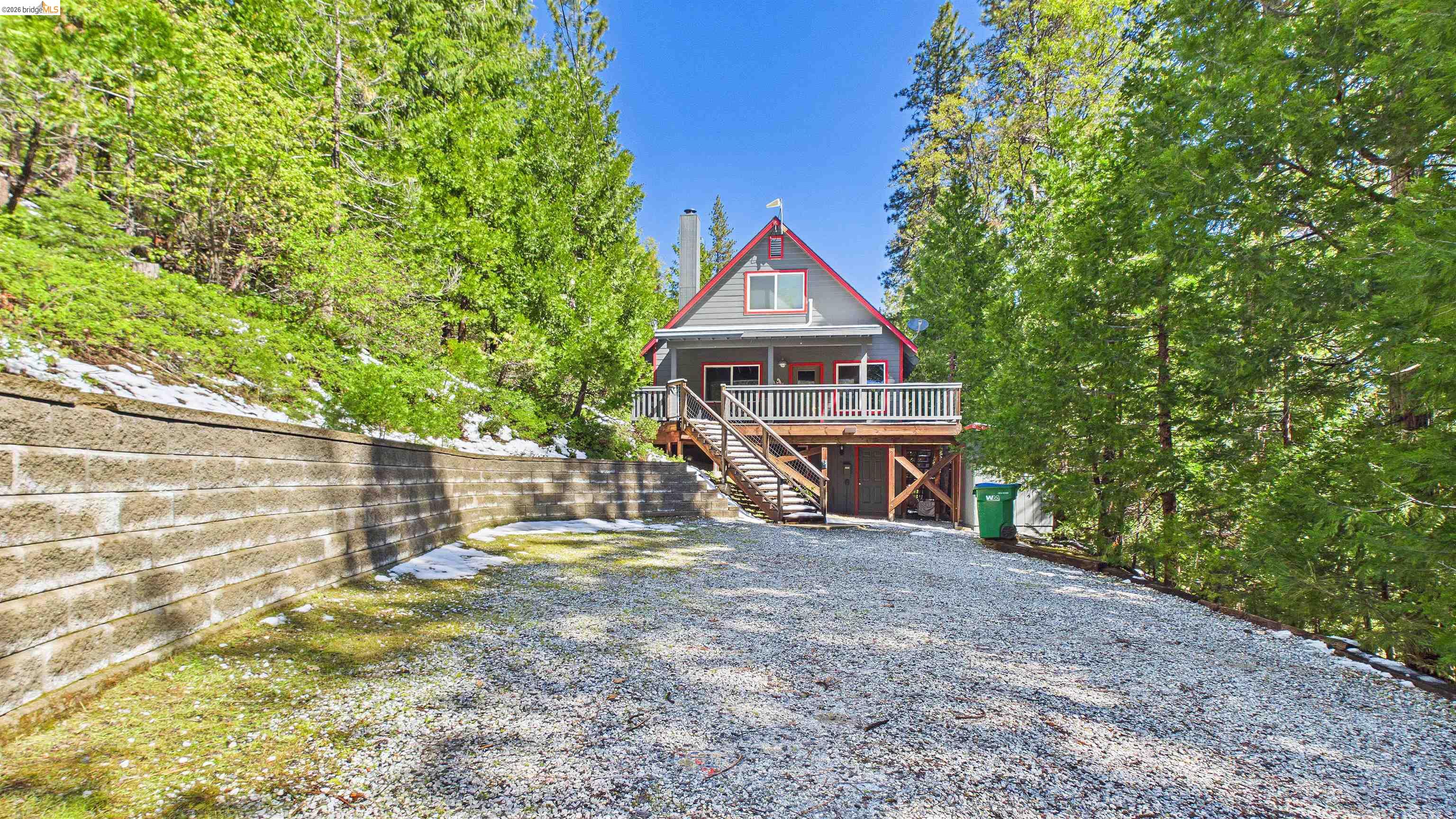 26570 Crystal Road Long Barn, CA 95335 - Photo 4 of 39 Elevated A-frame style residence featuring a spacious deck and a gray exterior with red trim