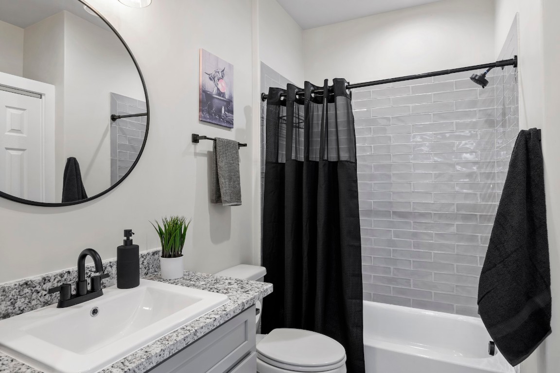 1003 Friendship Lane, Unit 301 Fredericksburg, TX 78624 - Photo 13 of 19 a bathroom with a sink toilet and shower