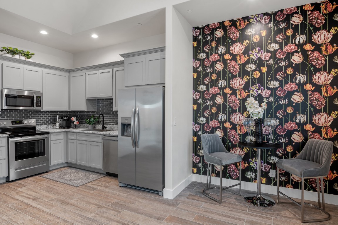 1003 Friendship Lane, Unit 301 Fredericksburg, TX 78624 - Photo 4 of 19 a kitchen with stainless steel appliances granite countertop a refrigerator and a stove top oven