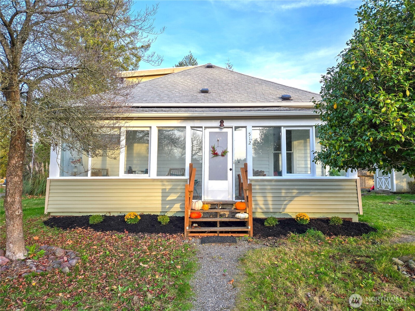 a front view of a house with a garden