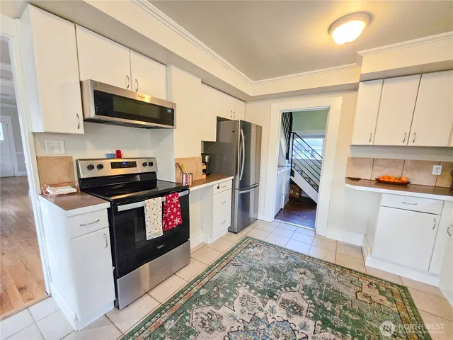 a kitchen with a sink cabinets and wooden floor