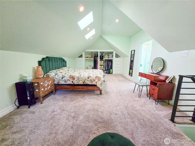 a bedroom with a bed window and a chair