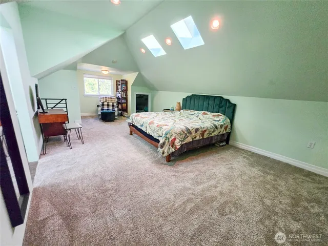 a bathroom with a sink a toilet a mirror and shower