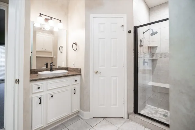 a view of bathroom with granite countertop cabinets and a view of bathroom