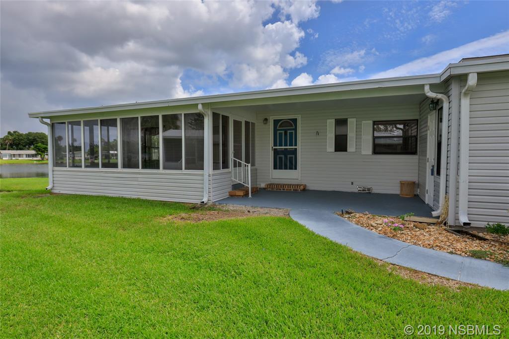 803 Navigators Way Edgewater, FL 32141 - Photo 2 of 27 a view of house with yard and floor to ceiling window