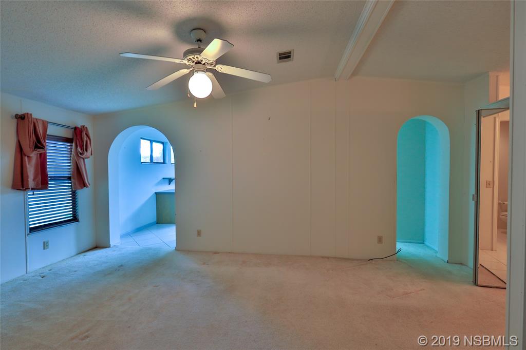 803 Navigators Way Edgewater, FL 32141 - Photo 17 of 27 a view of a livingroom with a chandelier fan and closet