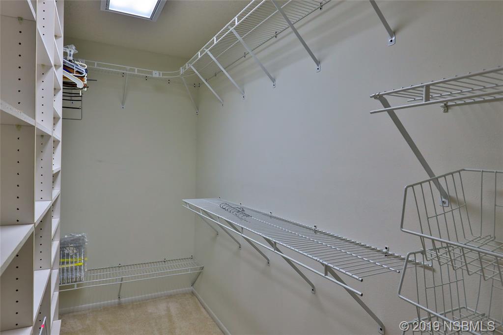 803 Navigators Way Edgewater, FL 32141 - Photo 22 of 27 a utility room with racks on the wall