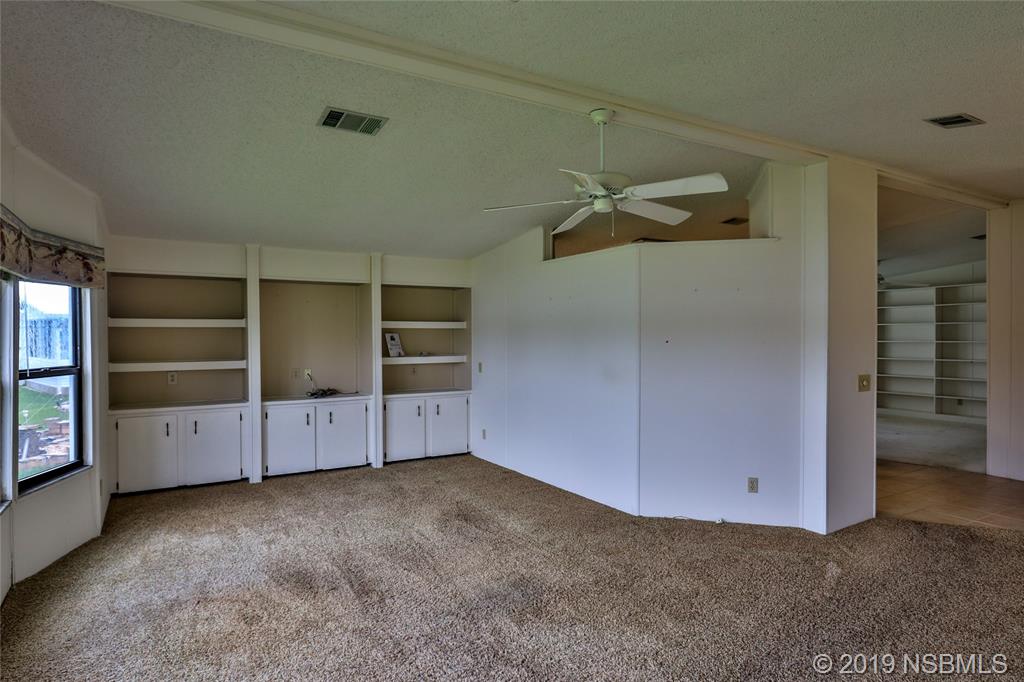 803 Navigators Way Edgewater, FL 32141 - Photo 6 of 27 a view of an empty room with a ceiling fan