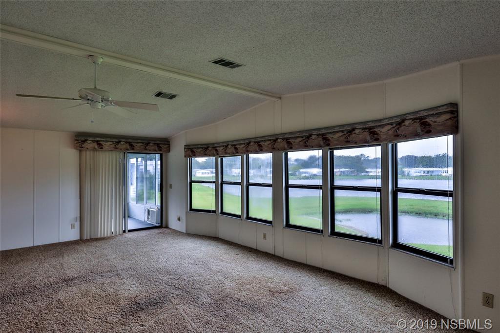 803 Navigators Way Edgewater, FL 32141 - Photo 7 of 27 a view of an empty room with a large window