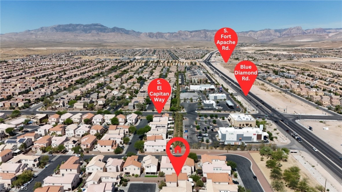 8934 Deep Ridge Court Las Vegas, NV 89178 - Photo 45 of 47 An aerial perspective reveals a vast residential community nestled against a majestic mountain backdrop.