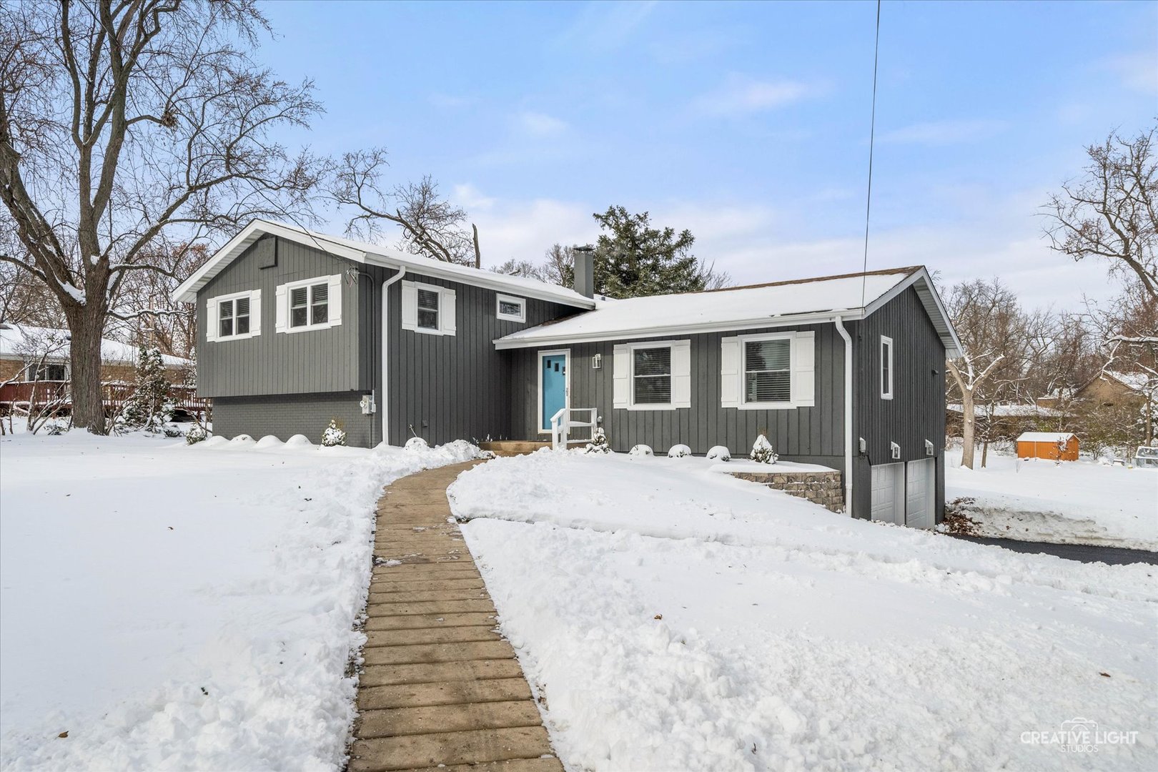 704 Plainfield Road Downers Grove, IL 60516 - Photo 1 of 36 a front view of a house with a yard covered in snow
