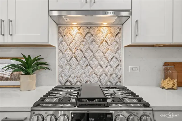 a stove top oven sitting inside of a kitchen