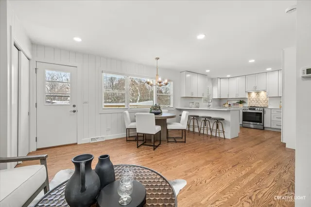 a living room with furniture and kitchen view
